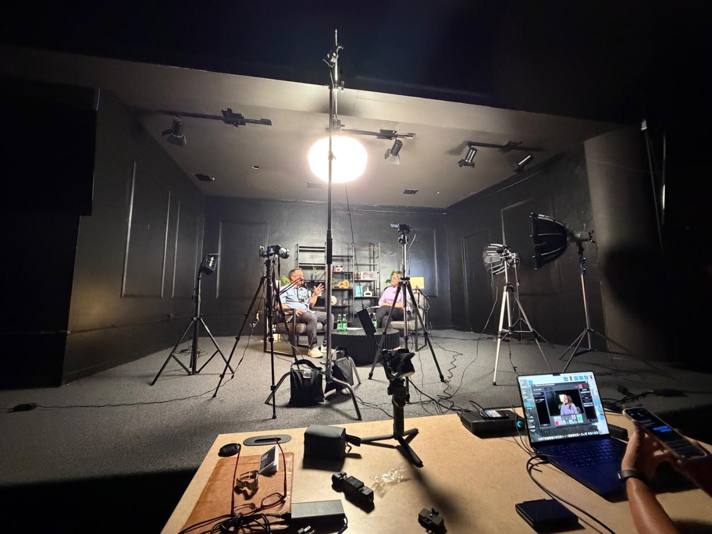 Interview set at Studio 1903 with cameras, softboxes and two guests mid-conversation